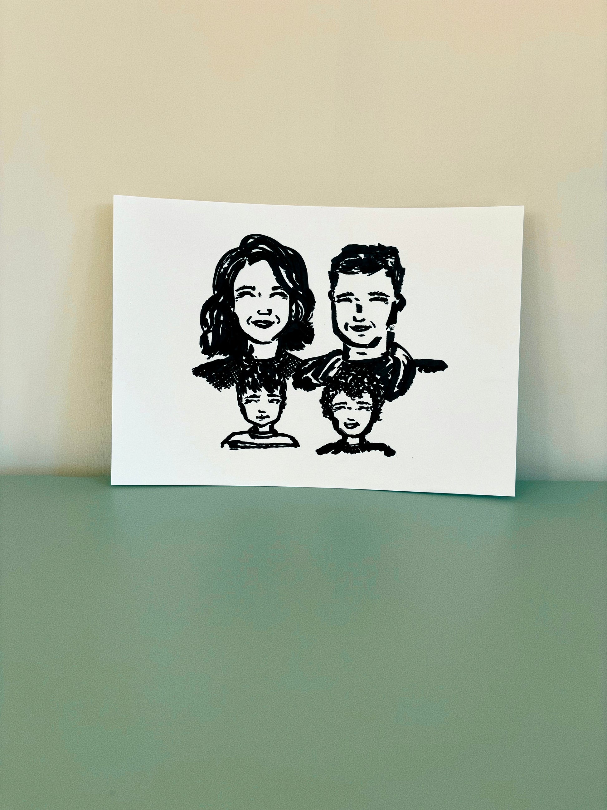 A cute hand drawn portrait of a family on premium card stock. 